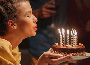 What is the tradition behind celebrating birthdays with cakes & candles?